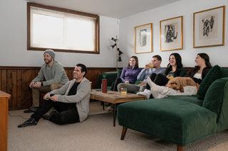 Friends playing video games in the downstairs living room in Cellar House.