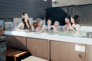 Group of friends relaxing and enjoying the Sound Oasis (hot tub) at Cellar House, creating memories and moments of pure joy.
